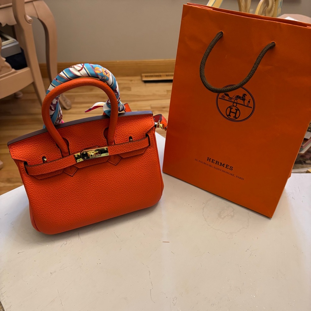 House of Hello. Orange pebbled leather mini bag “Not a Hermes” inside purse